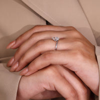 Claw prong setting solitaire diamond ring with a twisted shank in white gold.
