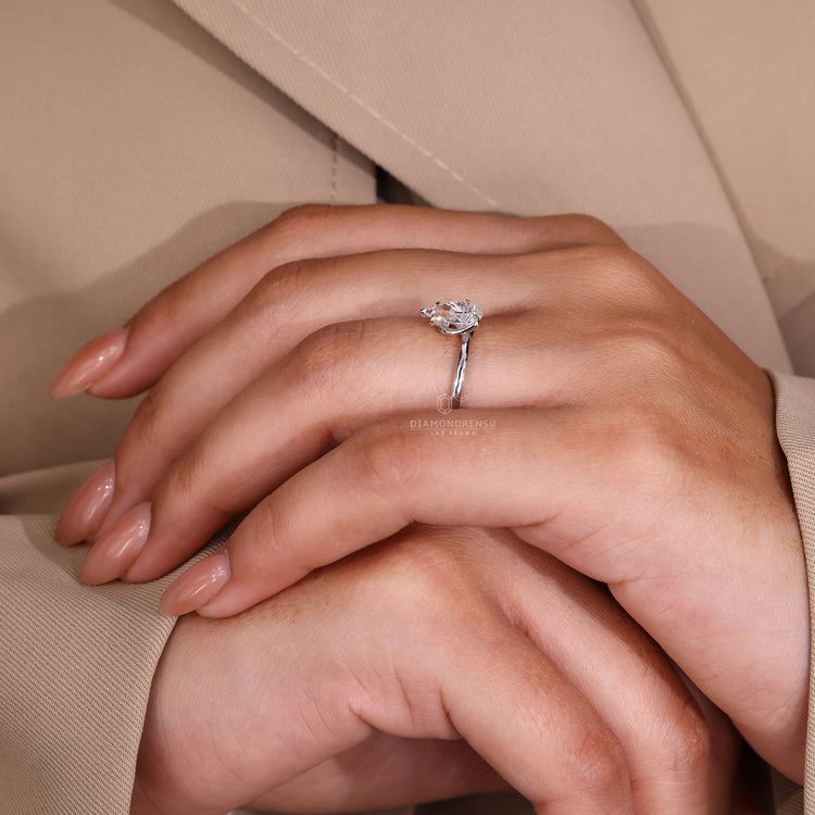 Claw prong setting solitaire diamond ring with a twisted shank in white gold.
