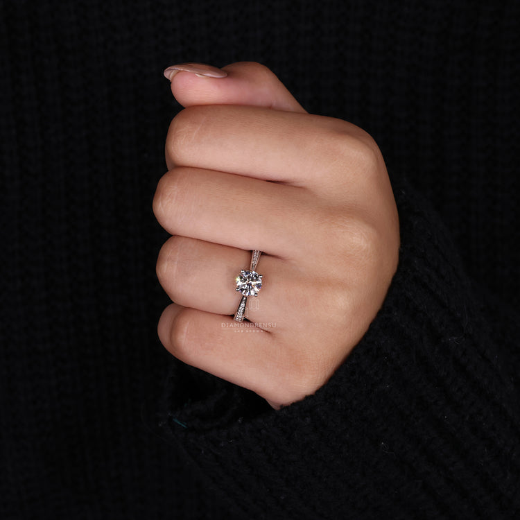 round cut side stone on tapered pave engagement ring.
