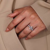 White gold ring with marquise cut diamond and zig zag pavé band.
