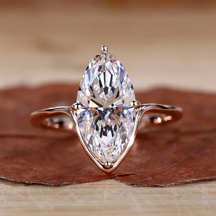 Marquise Diamond Engagement Ring with compass prong setting in rose gold.
