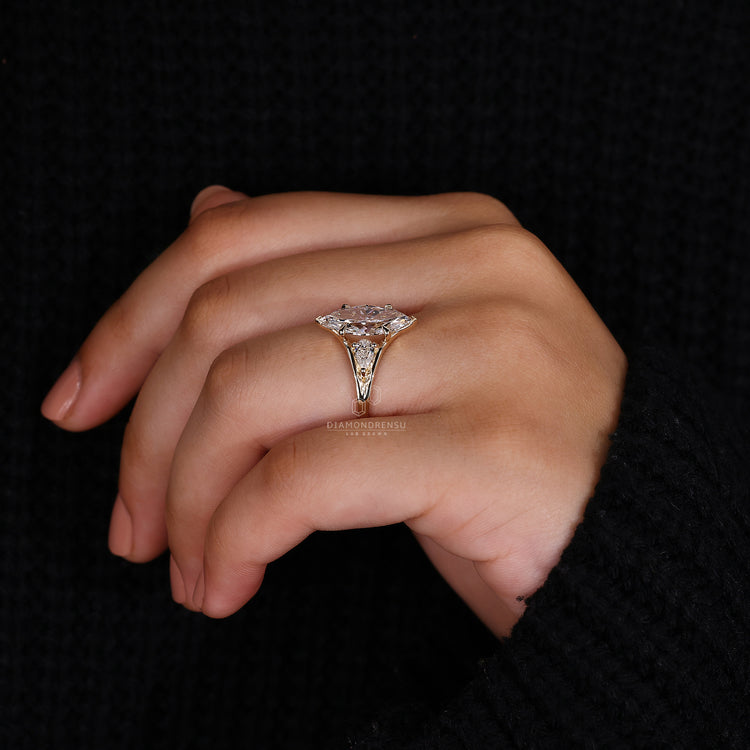 3 stone engagement ring in yellow gold band.
