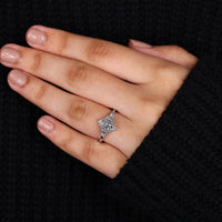 Trapezoid side stone set with marquise engagement ring.

