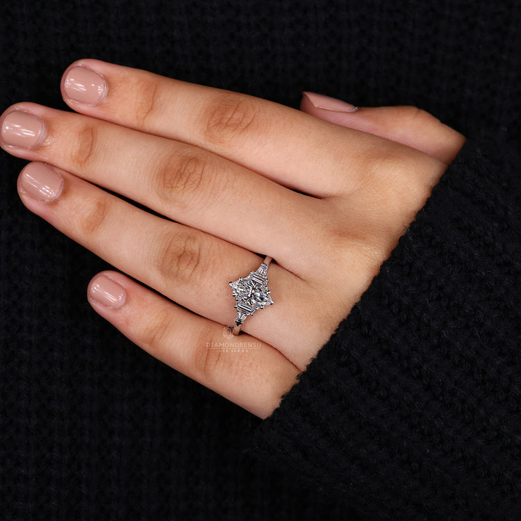 Trapezoid side stone set with marquise engagement ring.
