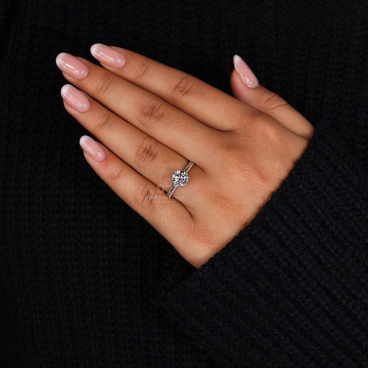 Prong setting ring with round diamond in rose gold knife edge design.
