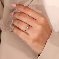 Round side stone in rose gold engagement ring.
