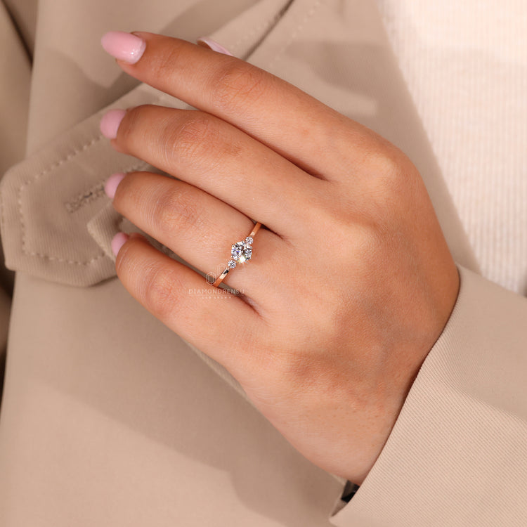 Round side stone in rose gold engagement ring.
