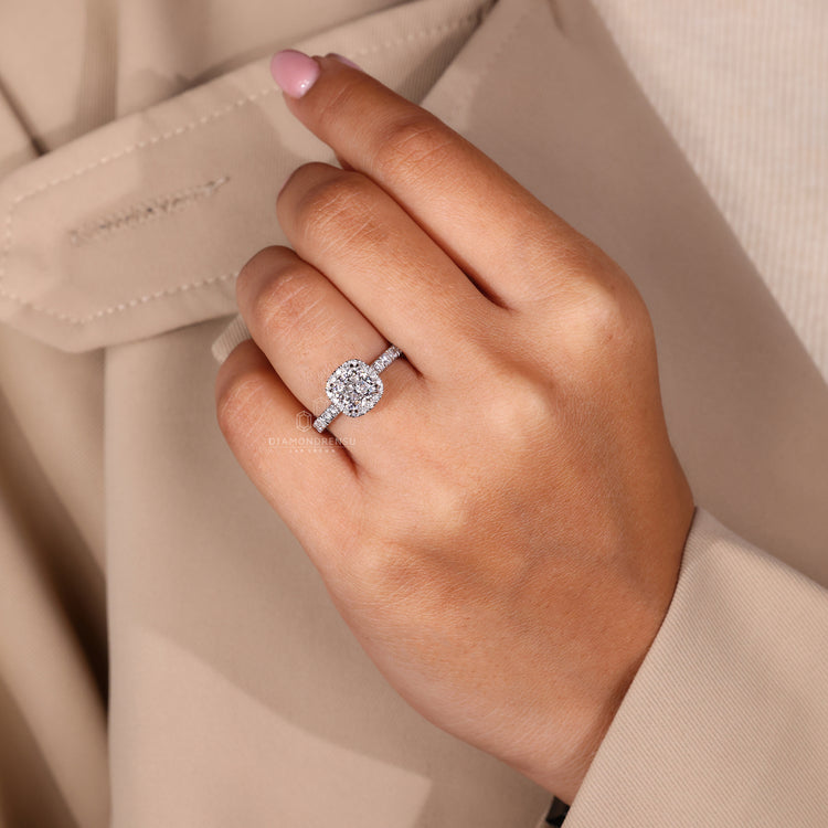 Custom diamond ring with cushion cut and round halo in gold.
