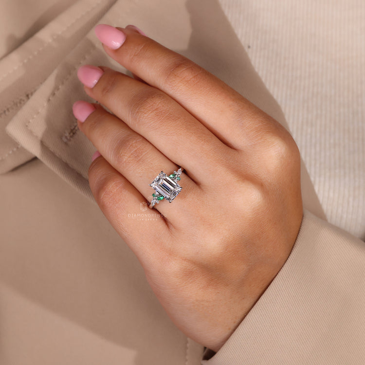IGI certified emerald cut ring with marquise and round accents.
