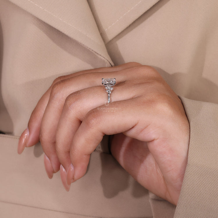 Handmade ring featuring a cushion cut diamond and round accents.
