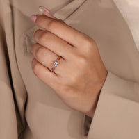 Twisted shank engagement ring with solitaire round diamond in rose gold.

