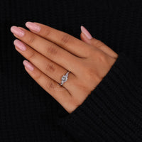 Round side stone ring with Portuguese cut diamond and claw prong setting.
