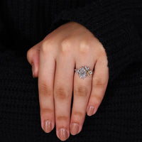 Split shank engagement ring with Dutch marquise and round side stones.
