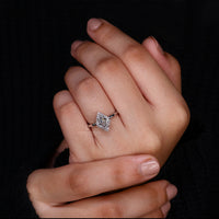 White gold engagement ring with round cut halo setting.
