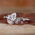 Diamondrensu engagement ring showcasing a pear-shaped diamond and round side stones.