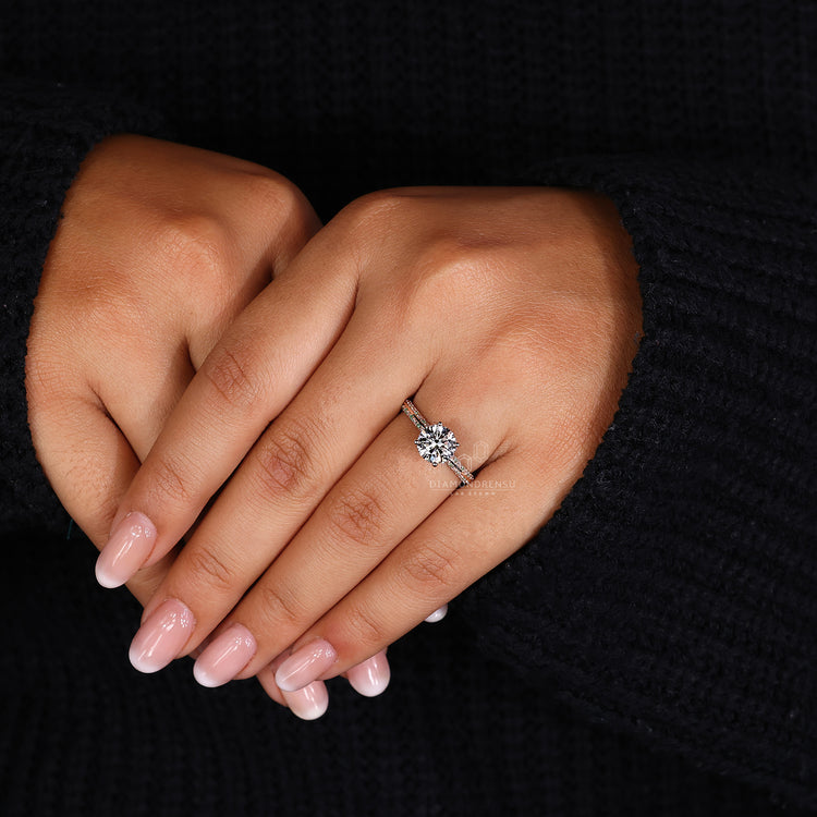 Custom diamond ring with round stone and knife edge pavé setting.
