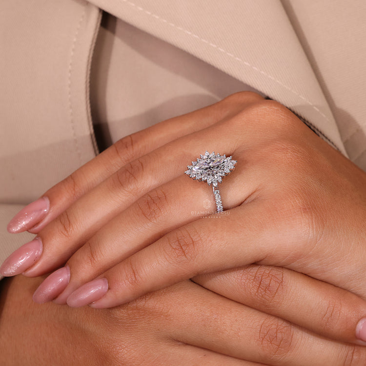 Pavé diamond ring with marquise cut centre and halo design.
