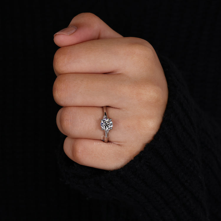 IGI certified ring with round brilliant cut center stone.
