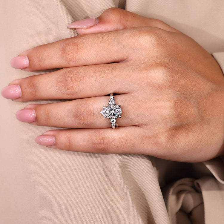 IGI certified diamond ring featuring pear and round accents.

