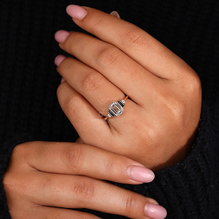 Handmade engagement ring with emerald cut diamond center.
