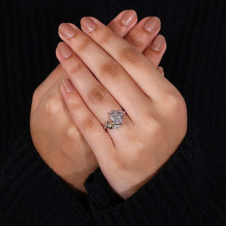Yellow gold ring with round side stones and Dutch marquise diamond.
