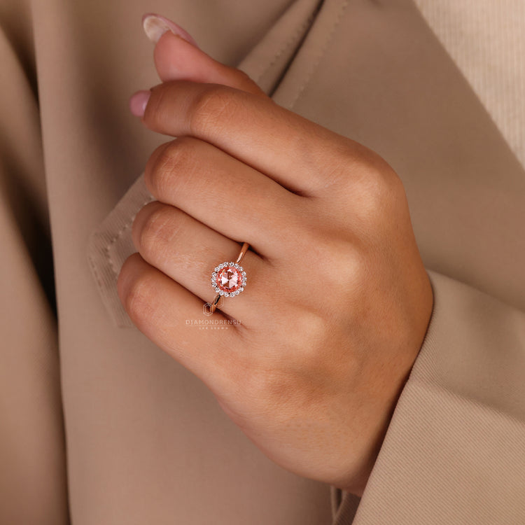 Lab grown diamond ring with halo and pink stone in rose gold.
