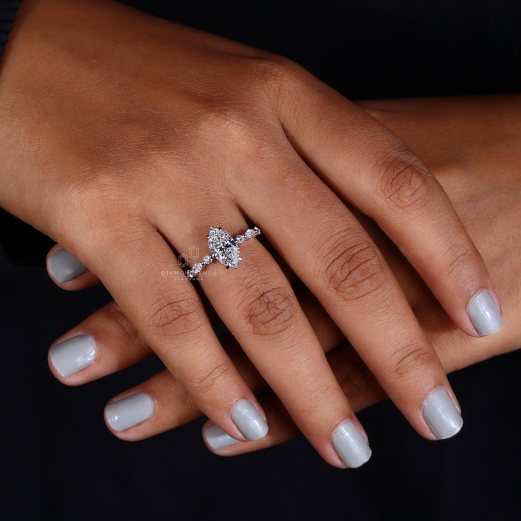 shared prong engagement ring with round side stones.
