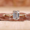 emerald cut diamond ring in yellow gold band.
