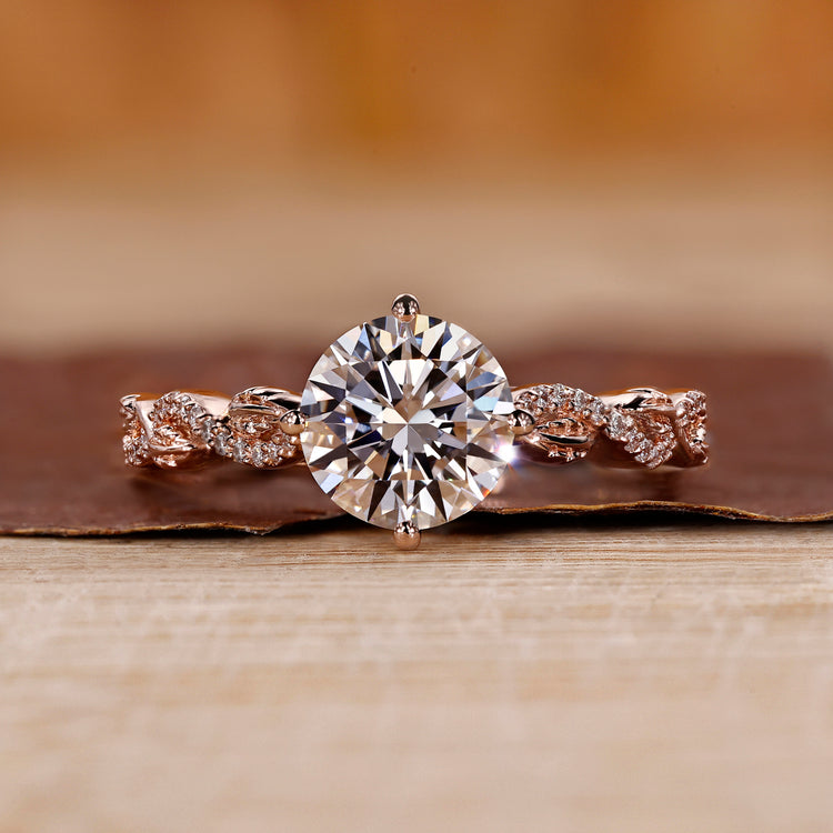 Rose gold diamond ring with round cut diamond and twisted pavé setting.

