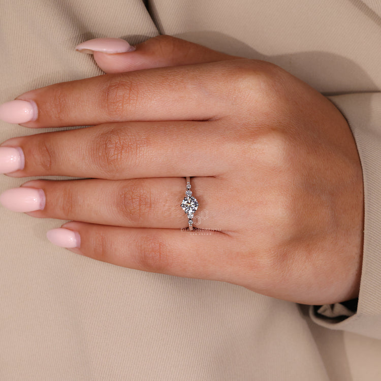Handmade engagement ring with five round diamonds in a row.
