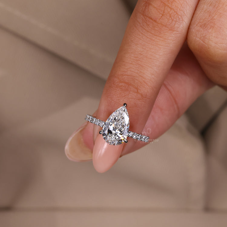 Lab grown diamond ring with 3 claw prong and pave band.
