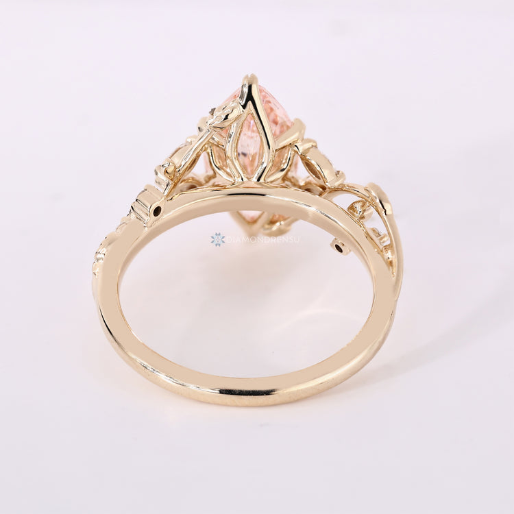 Pink diamond ring with marquise side stones.