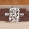 Radiant cut diamond ring with pave round diamond band.