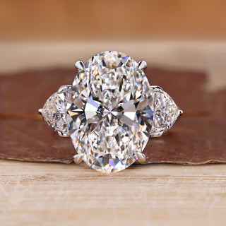 Three stone oval engagement ring with trillion side stones.