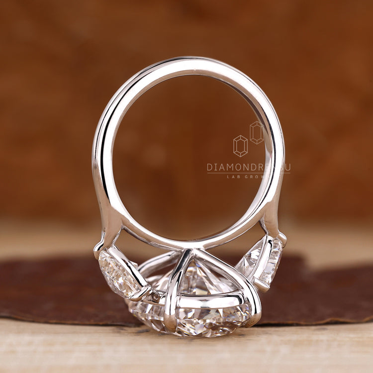 Four claw prong setting three stone oval ring.