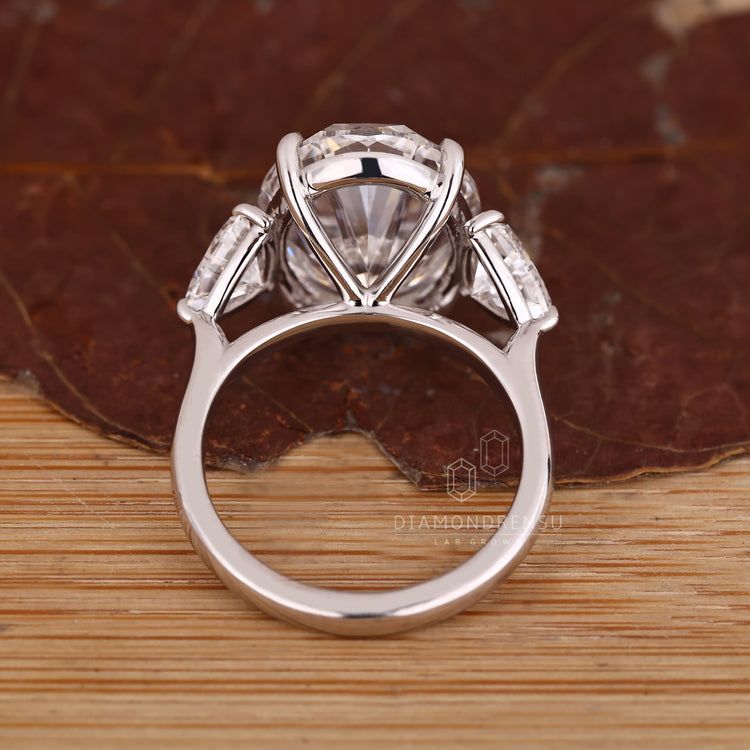 Custom diamond ring with oval centre and trillion side stones.