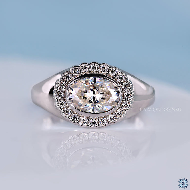 Oval diamond engagement ring with round diamond halo.
