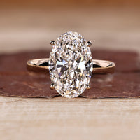 Oval cut diamond ring with hidden halo engagement design.