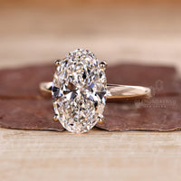 Four prong setting ring with oval diamond and hidden halo.