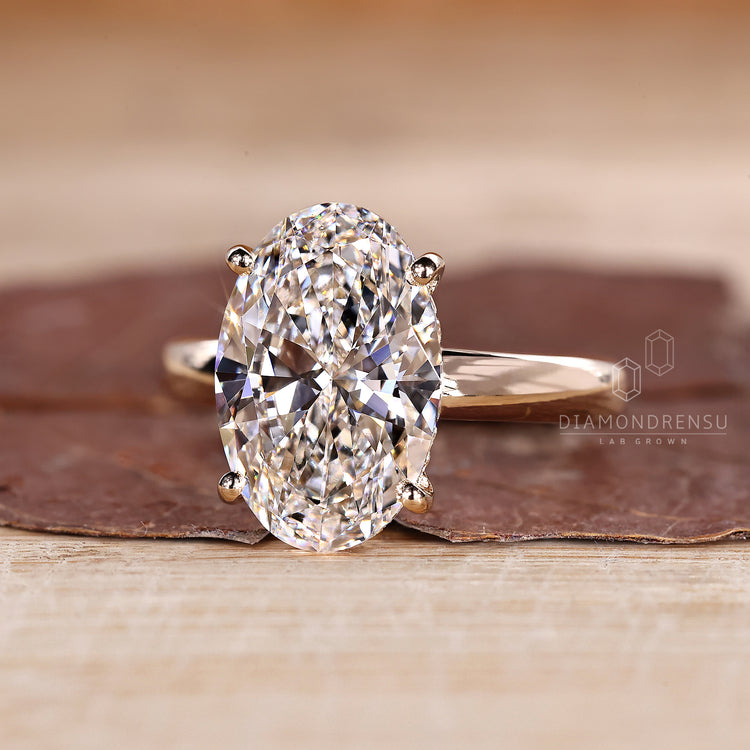Four prong setting ring with oval diamond and hidden halo.