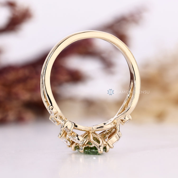 Green diamond ring with round and marquise stones.
