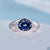 Oval moissanite ring with blue centre stone in solitaire style.
