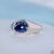 Gypsy set oval blue moissanite solitaire ring.
