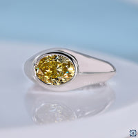Oval cut engagement ring in canary yellow gold finish.