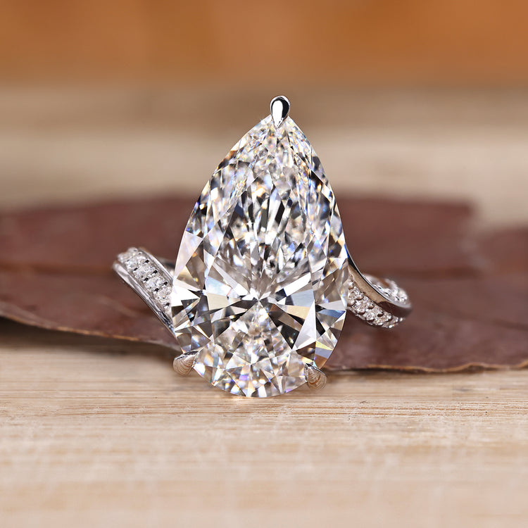 Pear cut diamond ring with double row pave band.