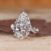 Pear cut diamond ring with bypass ring setting.