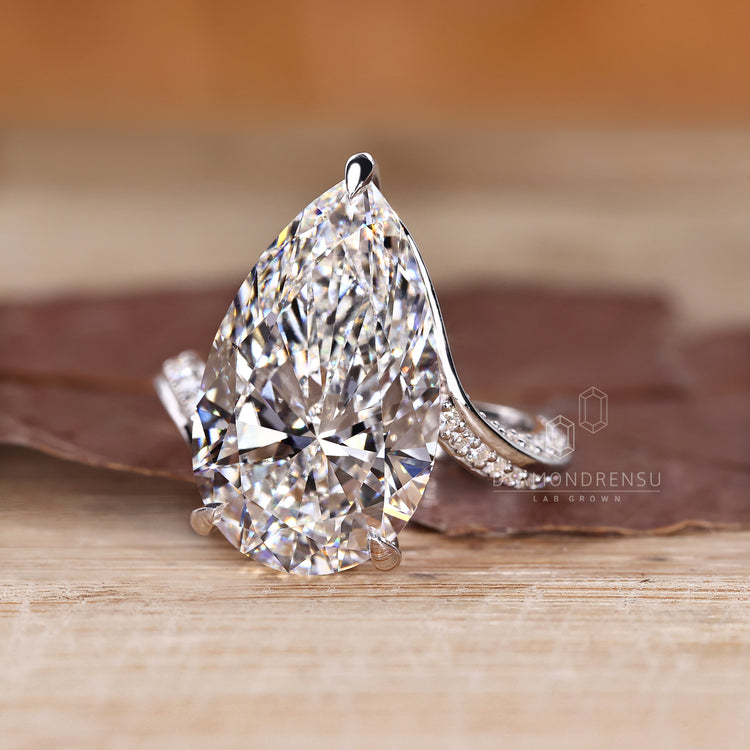 Pear cut diamond ring with bypass ring setting.