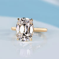 Cushion old mine diamond ring with four claw prongs.