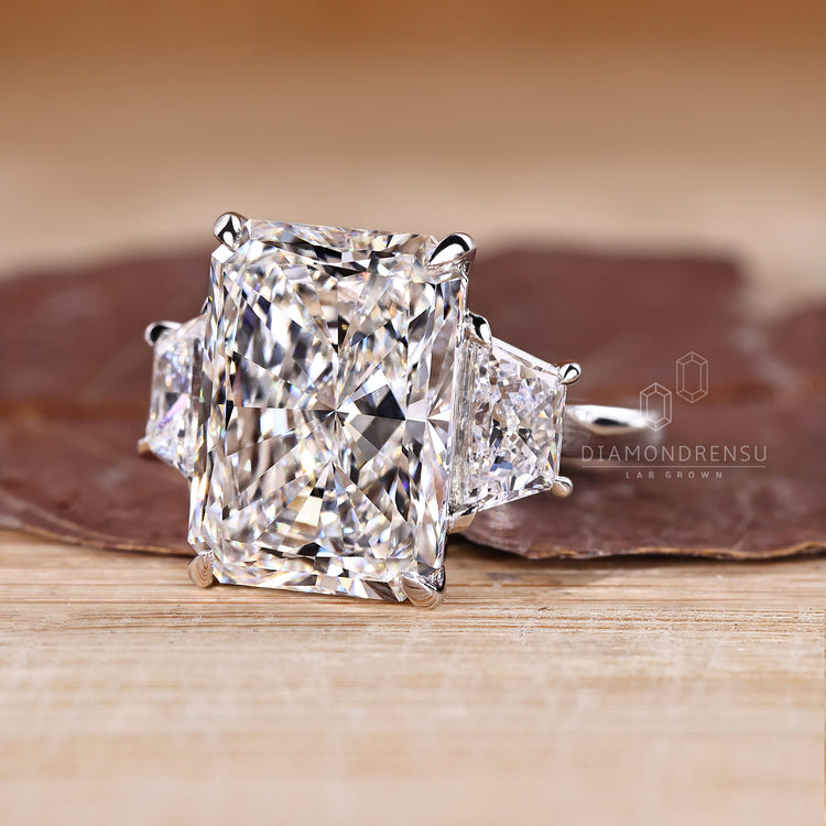Lab grown diamond 3 stone ring with radiant cut centre stone.