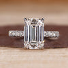 Pave diamond ring with emerald cut centre stone.